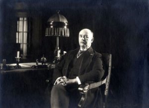 Ο Άλφρεντ Ρούντολφ Ζίμμερμαν ποζάρει πίσω από το γραφείο του. Φωτογραφία: Leren